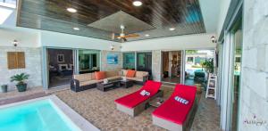 a living room with a swimming pool and a house at Villa Vie Luxury Retreat in Blagaj