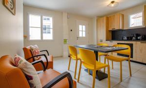 a kitchen and dining room with a table and chairs at Numéro 1 in Morvilliers