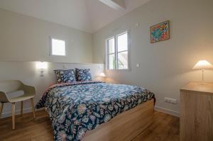 a bedroom with a bed and a desk and a window at Numéro 1 in Morvilliers