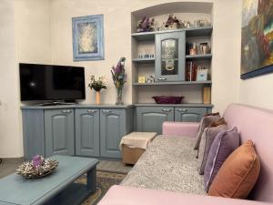 a living room with a couch and a tv at Settimo Cielo in Grosio