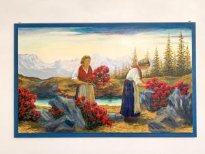 a painting of two women holding red flowers at Settimo Cielo in Grosio