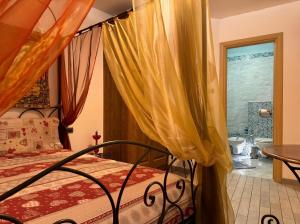 a bedroom with a bed and a bathroom at Settimo Cielo in Grosio