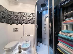 a bathroom with a sink and a toilet and a shower at Settimo Cielo in Grosio +5 photos