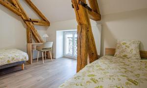 a bedroom with two twin beds and a desk at Numéro 2 in Morvilliers