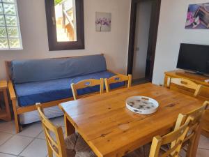 a living room with a wooden table and a couch at Villa Sunny Side - Panoramic View in Costa Paradiso