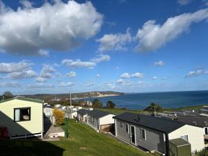 a view of a row of houses and the ocean at Beer Head Caravan Park B68 in Seaton