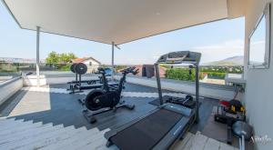 a gym with cardio equipment on the roof of a house at Villa Vie Luxury Retreat in Blagaj +105 photos
