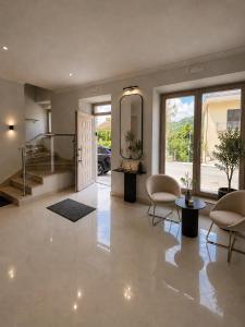 a living room with a staircase and chairs and a door at Fenisien Boutique Rooms in Contursi