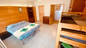 a room with two bunk beds and a table at villa Ada apartment in Cercivento