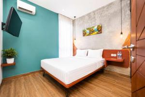 a bedroom with a bed and a blue wall at Noesa Heritage in Surabaya