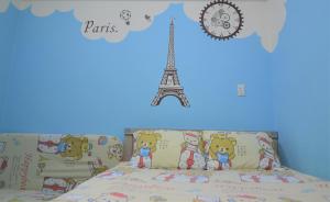 a bedroom with a bed and the eiffel tower at Love Fengchia in Taichung