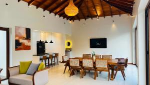 a dining room and kitchen with a table and chairs at Eden Collection Thalpe in Talpe
