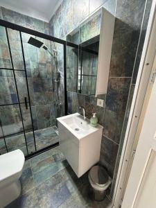a bathroom with a toilet and a sink and a shower at BEYAZEV Apart in Erdek