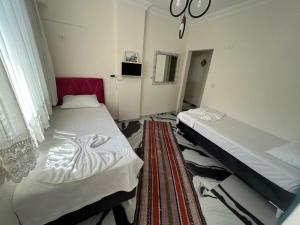 a room with two beds and a window at BEYAZEV Apart in Erdek +3 photos