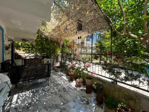 a patio with potted plants and a fence with plants at BEYAZEV Apart in Erdek