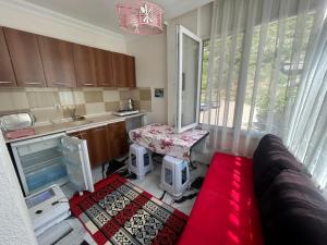 a kitchen with a couch and a table in a room at BEYAZEV Apart in Erdek