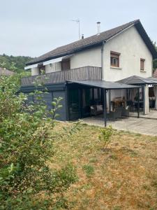 a house with a porch and a patio at Chez Nanou in Marmagne