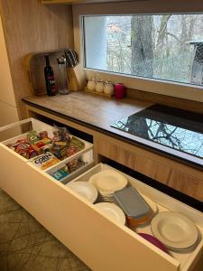 an open drawer in a kitchen with a window at Te Pishat in Brezovica