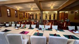 a large table in a room with chairs at Lush Garden Hotel in Arusha
