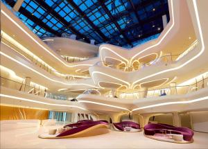a rendering of a building with escalators and chairs at ME by Meliá Dubai Residences in Dubai +59 photos