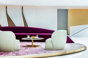 a room with two white chairs and a table at ME by Meliá Dubai Residences in Dubai