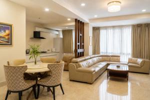 a living room with a couch and a table at Lotus Villa in Phuntsholing
