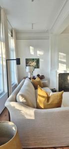 a bedroom with a bed with yellow pillows on it at EVERELMUS Boutique Hotel in Bruges