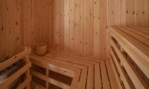 an empty wooden sauna with a bucket in it at Meliá Whale Lagoon Maldivas in Fenfushi +46 photos
