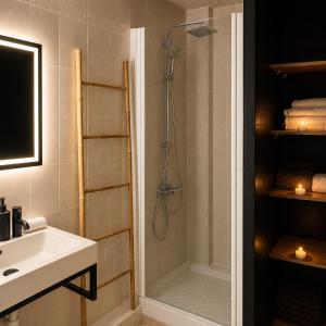 a bathroom with a shower and a sink at Le Petit Loft Vosgien -Escapade nature & cosy in Cornimont +17 photos