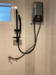 a phone hanging on a wall in a bathroom at Shwe Ooe Lay Guest House 2 in Pratunam +72 photos