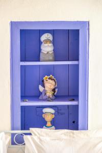 a blue shelf with toy figurines in it at Kali Strata 2 - Downtown in Symi