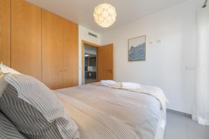a bedroom with a large bed and a chandelier at Portimão, Praia da Rocha in Portimão +49 photos