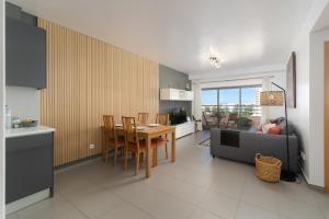 a kitchen and dining room with a table and chairs at Portimão, Praia da Rocha in Portimão