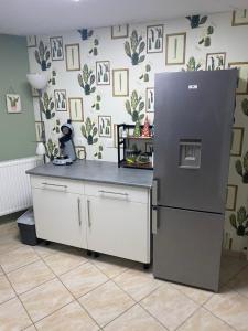 a kitchen with a black refrigerator in a room at Chez Nanou in Marmagne
