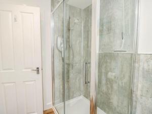 a shower with a glass door in a bathroom at The Old Post Office in Ventnor +22 photos