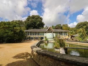 a large building with a pond in front of it at The Old Post Office in Ventnor