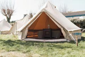 a large tent with a table in a field at The Glamping Spot - Douarnenez in Plonévez-Porzay +18 photos