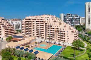 an aerial view of a large apartment building with a swimming pool at Portimão, Praia da Rocha in Portimão