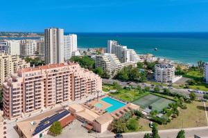 an aerial view of a city with buildings and the ocean at Portimão, Praia da Rocha in Portimão