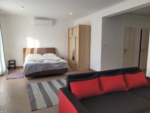 a living room with a couch and a bed at Villa Balifornia in Balatonboglár +32 photos