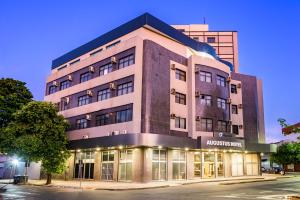 a large building on a city street at night at Plaza Inn Augustus - Downtown in Goiânia