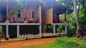 a house with a balcony on the side of it at Thehideout kurunegala in Kurunegala