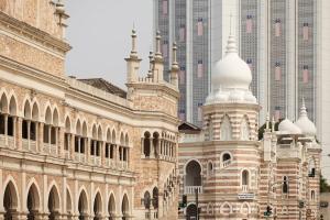 a large building with tall buildings in the background at Meliá Kuala Lumpur in Kuala Lumpur
