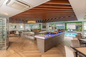 a hotel lobby with a bar and a pool at Meliá Kuala Lumpur in Kuala Lumpur