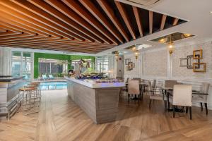 a kitchen and dining room with a bar and a pool at Meliá Kuala Lumpur in Kuala Lumpur +28 photos