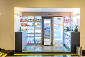 a refrigerator with its doors open in a store at Plaza Inn Augustus - Downtown in Goiânia