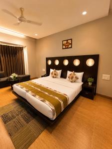 a bedroom with a large bed with two cats on it at Hotel Cymbal -Sector 31 Gurgaon in Gurgaon +67 photos