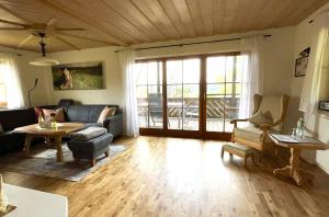a living room with a couch and a table at Allgäuer Ferienhäusle in Argenbühl