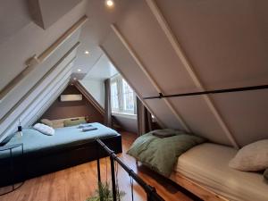 a attic room with two beds and a mattress at B&B Hendricus in Hoofddorp