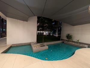a swimming pool in the middle of a building at Family's penthouse in Dhaka